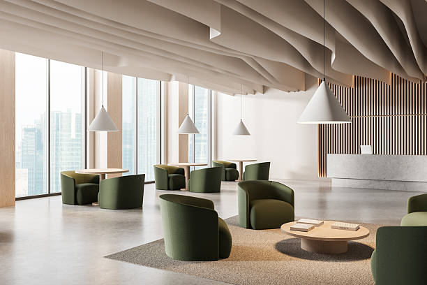 istock Modern spacious office lounge with green armchairs, round tables, and sculptural ceiling in high-rise building interior, showcasing minimalist design style. 3D Rendering 2214546167