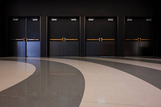 Modern Office Building Interior with Black Doors and Gray Flooring