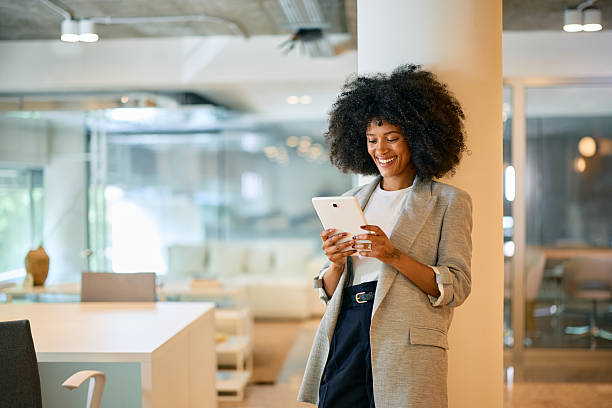 istock Smiling businesswoman using digital tablet in modern office 2214551288