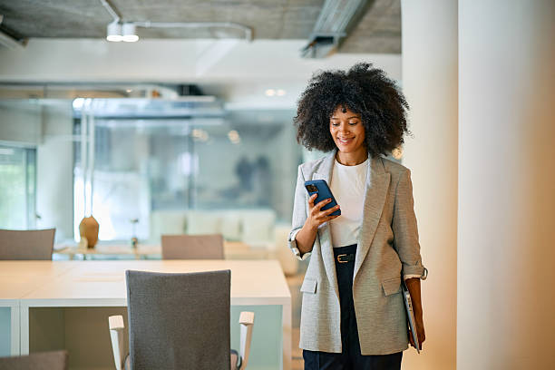 istock Young businesswoman using smartphone in modern coworking office 2214551309