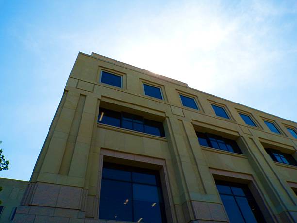 Building exterior on sunny day with blue sky.