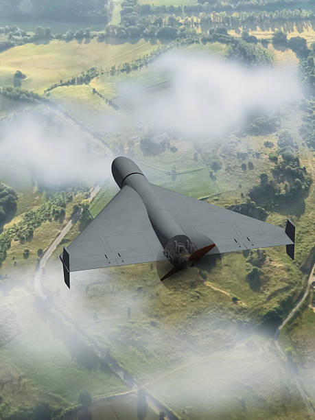 istock A modern military drone flies over land covered with forests and fields. 2214552401