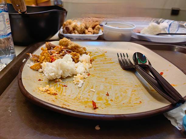 The remaining bone and rice left on a plate.