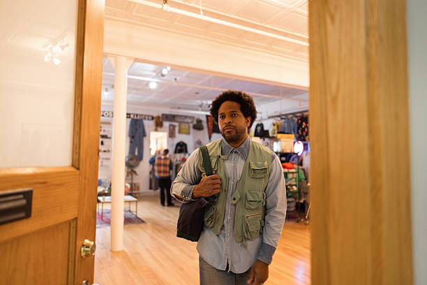 Small business owner walking into a vintage clothing store, preparing to start a productive day filled with retail opportunities