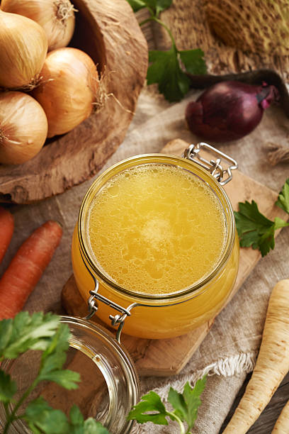istock Bone broth in a glass jar with fresh root vegetables 2214557779