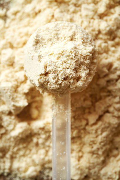 istock Whey protein powder in a measuring scoop, top view 2214558574