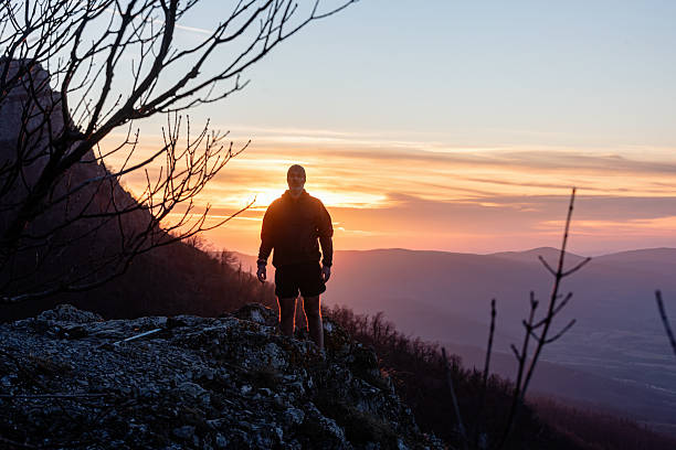 istock Mountaineer posing on mountain top at sunset after hiking adventure 2214559051