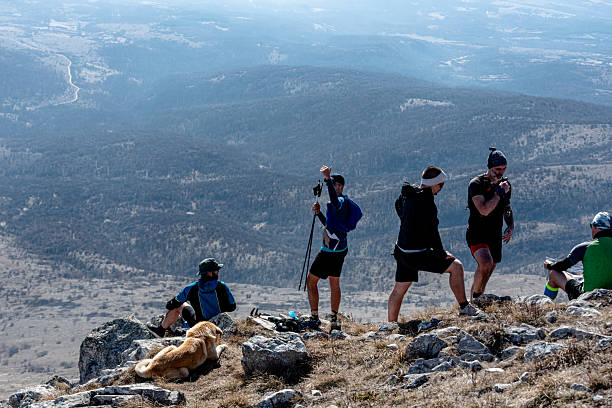 istock Hikers resting with dog on mountain top enjoying scenic view 2214559906