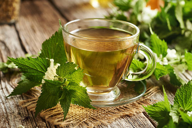 istock Fresh white dead-nettle blossoms and leaves with a cup of herbal tea 2214560420