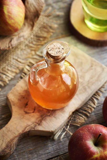 istock Apple cider vinegar in a glass jug with fresh red apples 2214560629