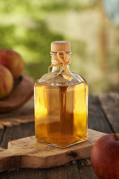 istock Apple cider vinegar in a glass bottle with fresh red apples 2214560637