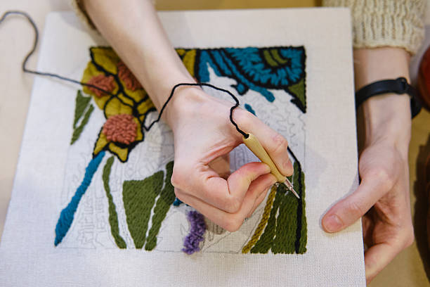 istock Handcrafting with punch needle embroidery on fabric canvas 2214566563