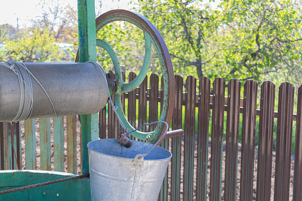 Rusty iron water pump outdoors in the field.