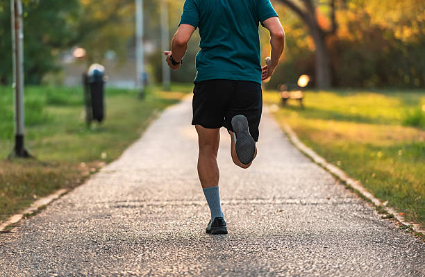 istock Male runner or tracker running or jogging at the park, active healthy lifestyle. 2214570553