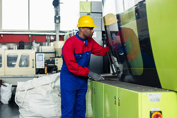 Mid adult Latin American man working at the PVC production factory and checking the quality of production