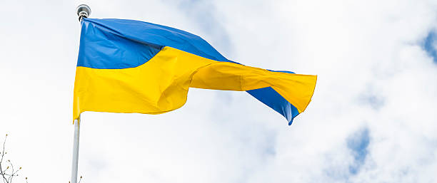istock Ukrainian flag waving in the cloudy sky 2214574116