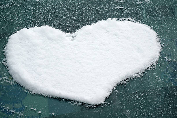 istock snow in heart shape on windshield of the car 2214574521