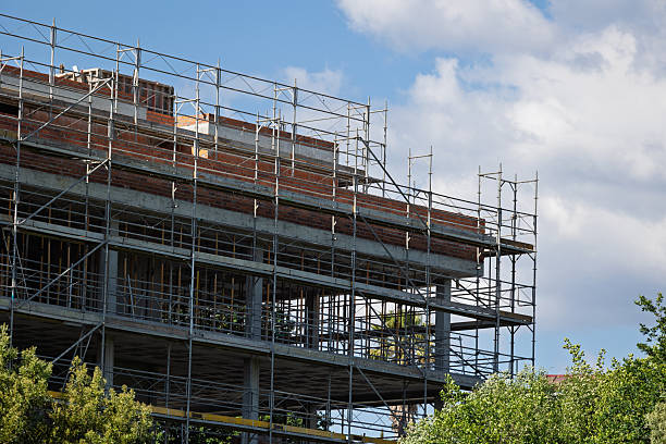 istock Building under construction with scaffolding and cloudy sky 2214574811