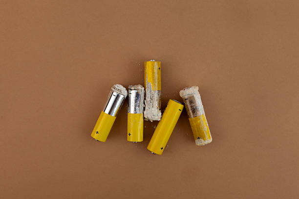 istock Old used batteries in poor condition. Oxidized and leaking alkaline batteries. Cathode is damaged, caustic white powder of potassium hydroxide is formed. Problems with recycling electronic waste 2214578754