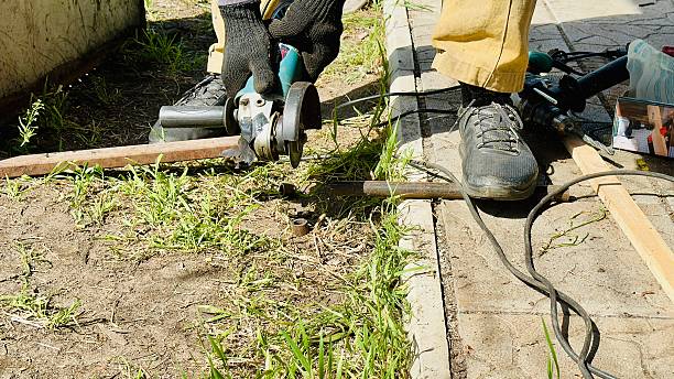 istock craftsman cutting metal with angle grinder outdoors 2214578967