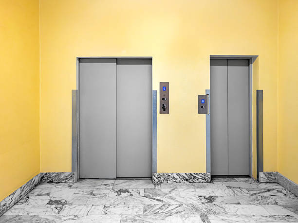 istock Elevator doors in lobby with yellow walls 2214581582