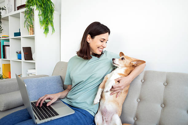 istock Woman enjoying quality time with her dog while working 2214583940
