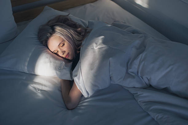 istock Young woman on bed 2214584063