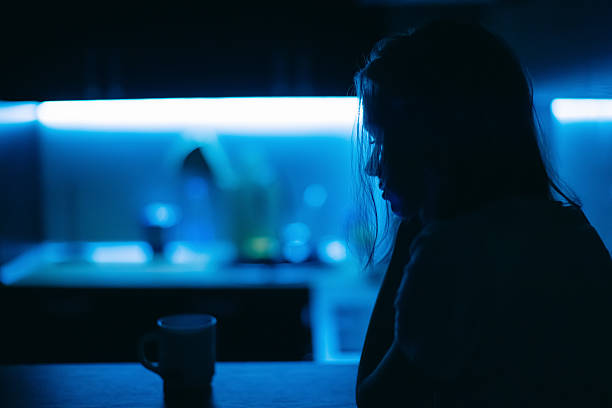istock Young woman in kitchen at night 2214584109
