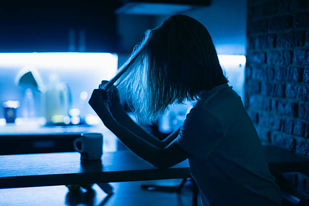 Young woman in kitchen at night
