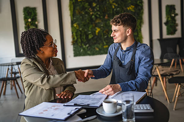 istock young man entrepreneur handshake with female financial adviser 2214585564