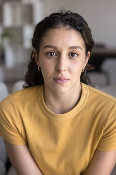 istock Serious beautiful young Latin woman looking at camera 2214586717