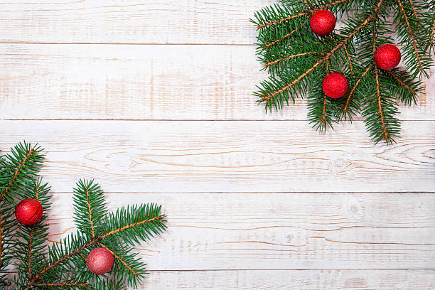 istock Christmas background - fir branches and red ornaments on a white wood table. Flat layout, top view composition border with copy space 2214589510