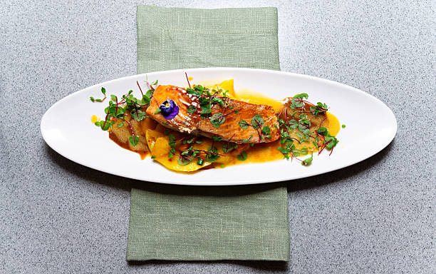 istock Elegant plated salmon with mango puree. 2214590454