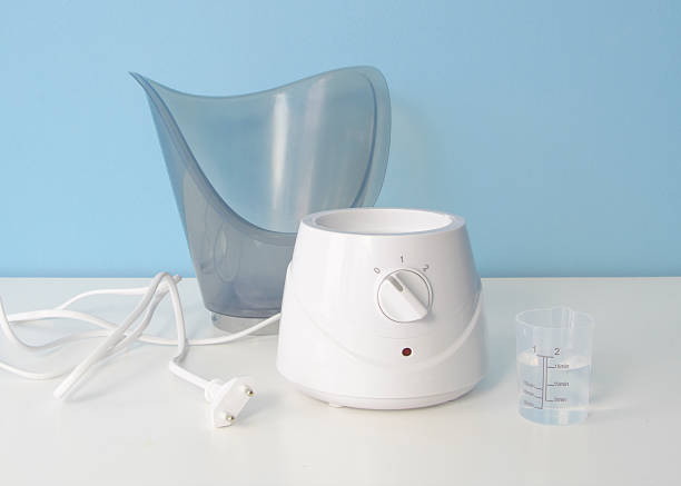 istock There is a white device on a table with a water container called a facial steamer 2214594485