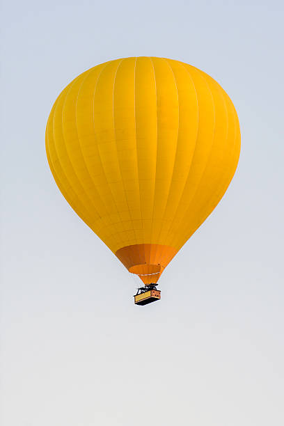 istock Yellow hot air balloon in a completely clear sky 2214594504