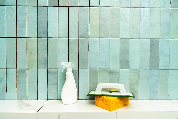 istock Work in progress in a bathroom focused on applying epoxy grout with a spatula for tile repair 2214594555