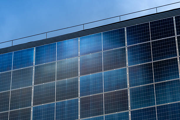 Close-up perspective view shows solar panels attached to building. Clean energy generation for environment.