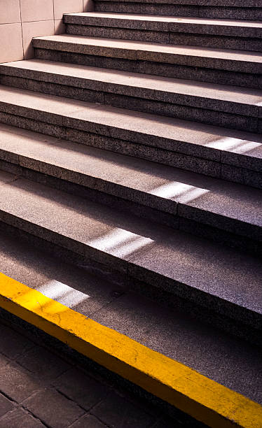 istock Granite stairs with yellow and white stripes leading upwards 2214596761