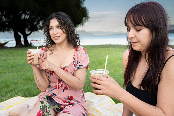 A heartfelt snapshot of a father and son enjoying a casual meal at a picnic table. The natural backdrop and warm interaction highlight family connection and time spent unplugged.