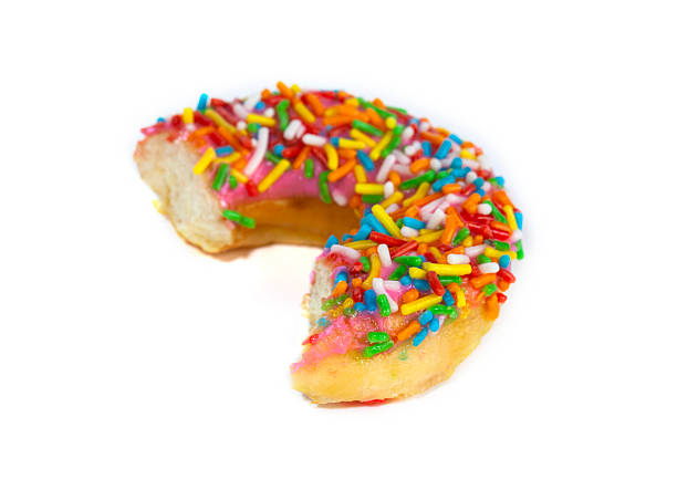 Bitten donut with colorful chocolate sprinkles topping isolated on white background