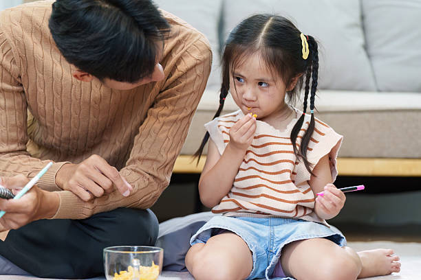 istock Parenting and Learning. A father engaging with his daughter as they prepare for back-to-school activities. 2214610048