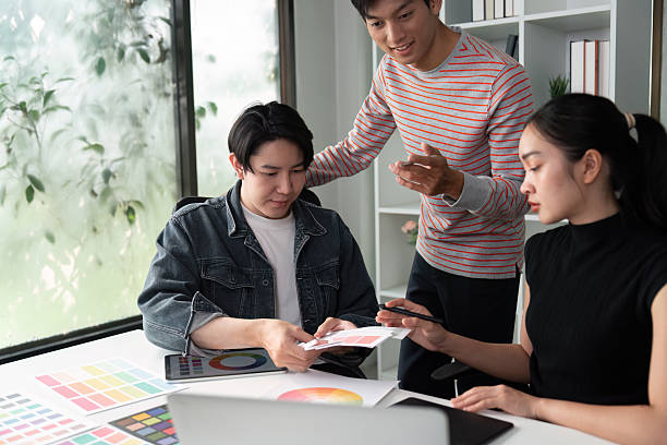 istock Design Review and Team Synergy. A team evaluating design concepts and sharing feedback in a collaborative setting. 2214610395
