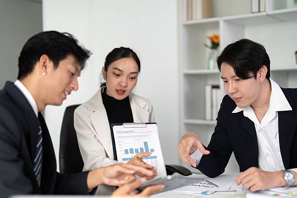 istock Data Presentation and Collaboration. Team members engaging in a business discussion with charts and digital tools. 2214610970