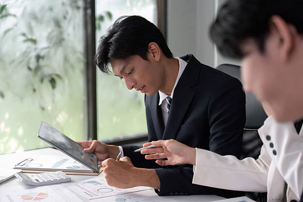 istock Focused Analysis and Planning. Professionals reviewing data and notes in a productive office environment. 2214610982