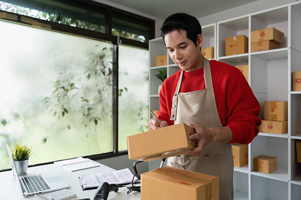 istock Quality Control and Package Preparation. An entrepreneur examining packages and preparing them for delivery in a stylish workspace. 2214611004