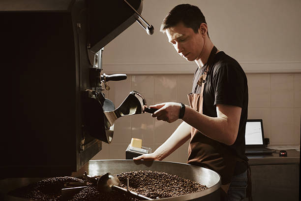 istock Highly Skilled Barista Operating a Coffee Roaster Machine with Expertise 2214611578