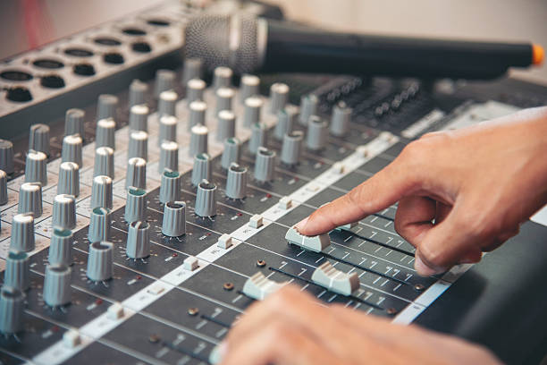istock Production sound engineer woman hands adjusting volume equalizer voice, mixing console. DJ sound engineering working on recording studio mixing voice control.  Producer remix tune music sound record 2214617178