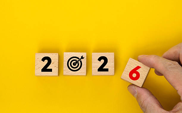 istock Wooden cubes with numbers 2026 and target icon on yellow background 2214619057