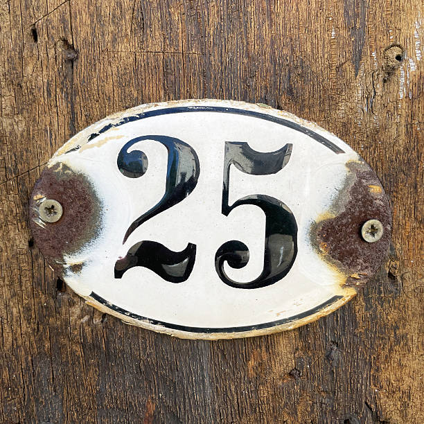 istock old rusty house number twenty-five 25 plaque on wall 2214619653