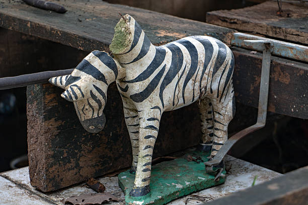 istock The damaged statue of zebra with a falling head, close up. 2214619733